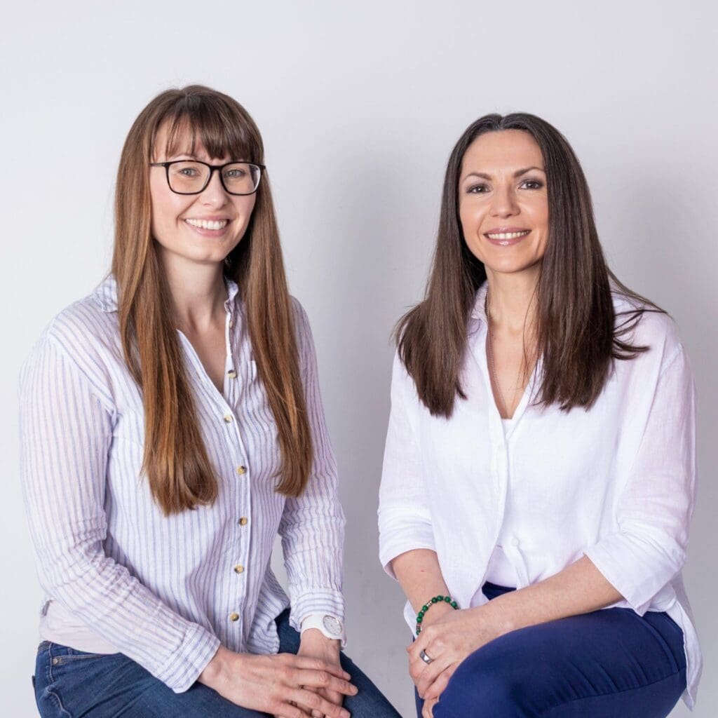 Two Health Recovery Clinic practitioners smiling in a studio portrait