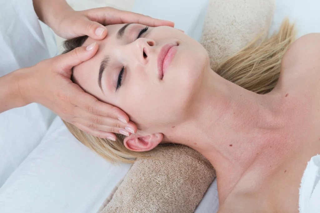 Patient receiving a gentle head and facial massage during treatment