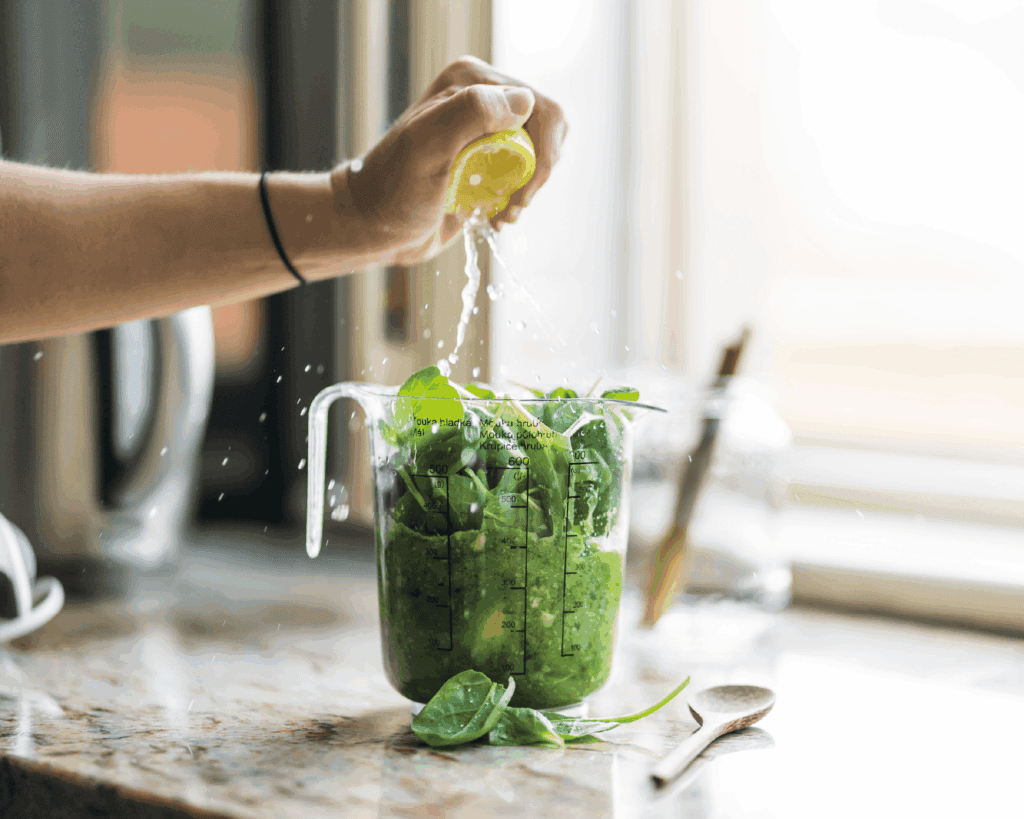 Preparing a nutritious green smoothie with fresh ingredients